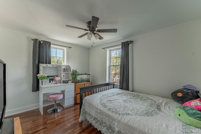 bedroom with multiple windows, dark wood-type flooring, and ceiling fan