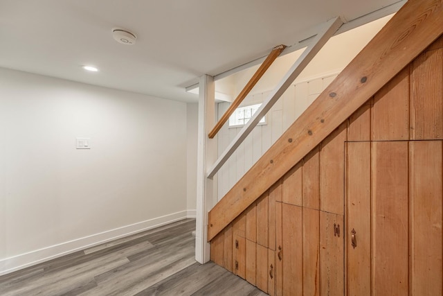 stairway with hardwood / wood-style flooring