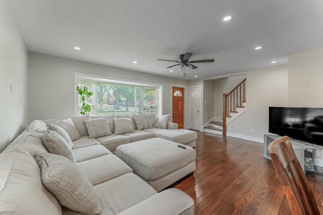 living room featuring ceiling fan and dark hardwood / wood-style flooring