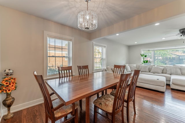 dining room featuring ceiling fan with notable chandelier and hardwood / wood-style floors