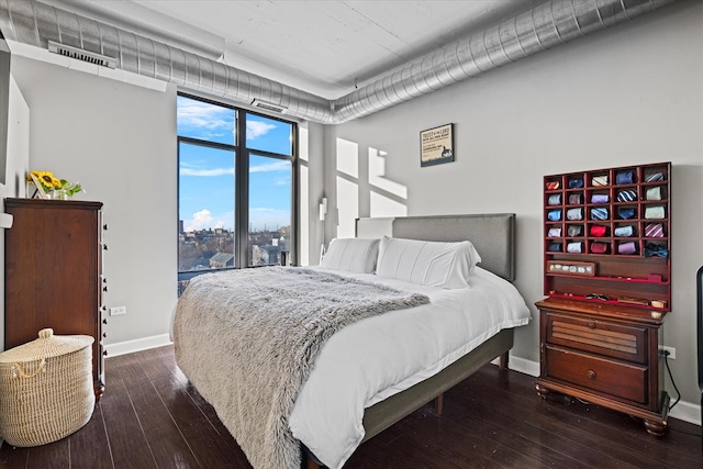 bedroom with dark wood-type flooring