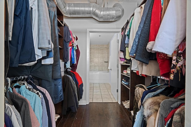 walk in closet with hardwood / wood-style flooring