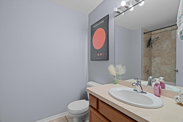 bathroom with tiled shower, vanity, toilet, and tile patterned flooring