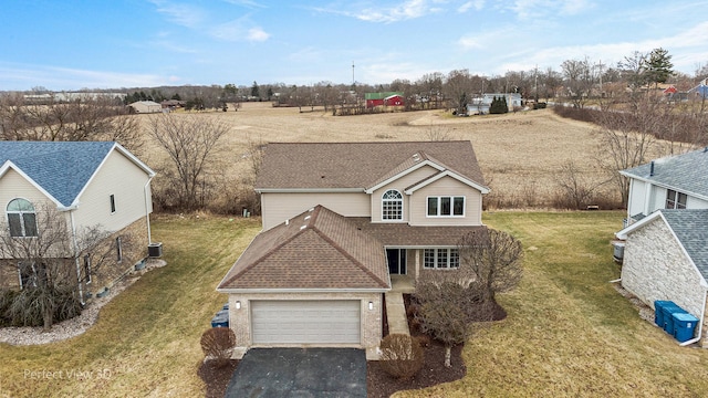 view of front of property with a garage and a front yard