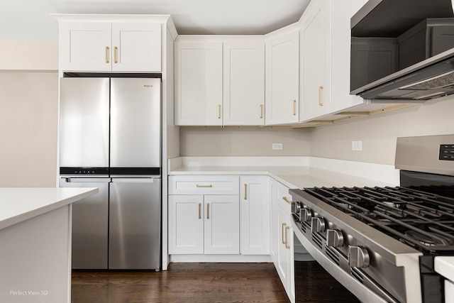 kitchen featuring white cabinetry, appliances with stainless steel finishes, and dark hardwood / wood-style floors