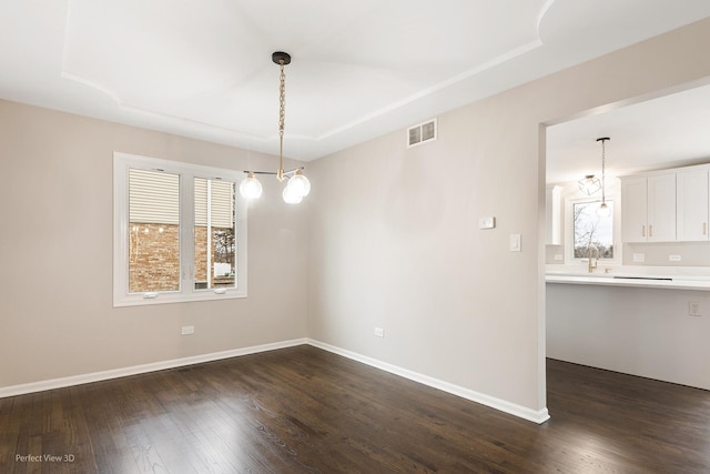 unfurnished dining area featuring dark hardwood / wood-style flooring