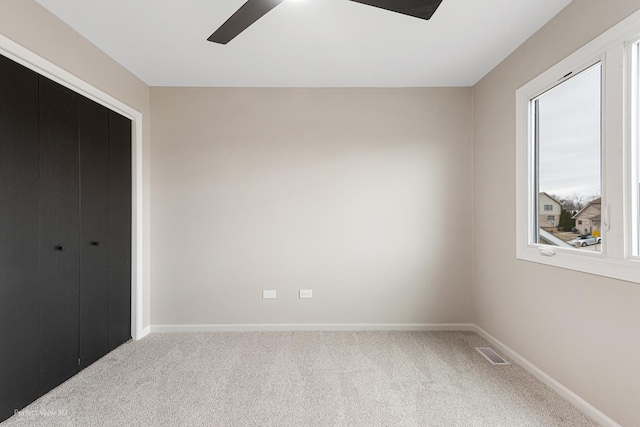 unfurnished bedroom with carpet floors, ceiling fan, and a closet