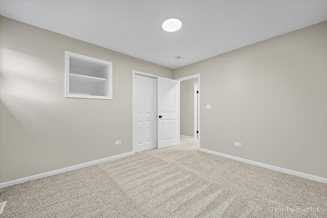 unfurnished bedroom featuring a closet and light carpet