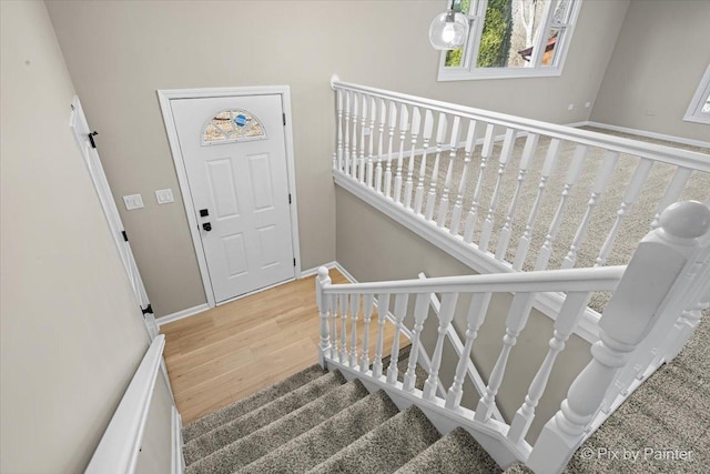 stairway with hardwood / wood-style flooring