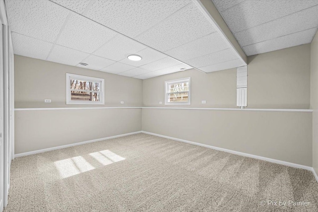 basement featuring carpet floors and a paneled ceiling