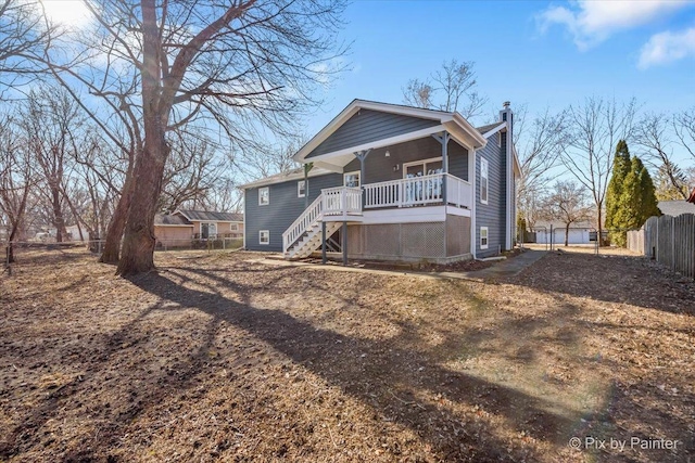 back of property featuring covered porch