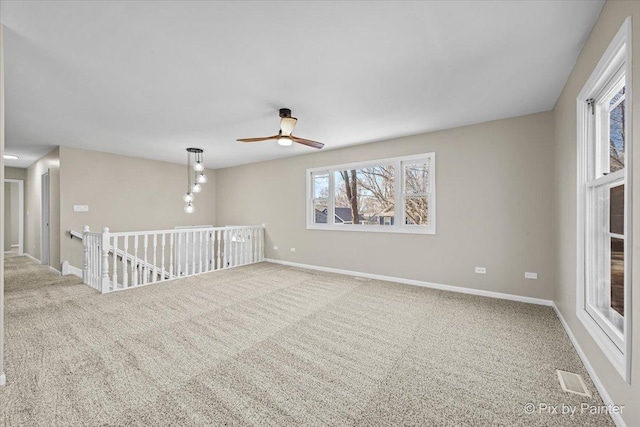 unfurnished room featuring ceiling fan and carpet flooring