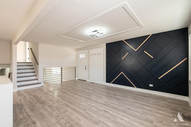 foyer entrance with light hardwood / wood-style floors