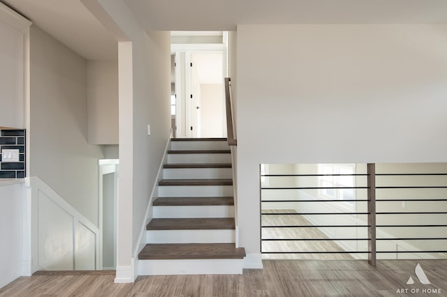 stairway with hardwood / wood-style flooring