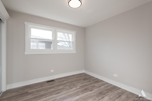 empty room with hardwood / wood-style floors