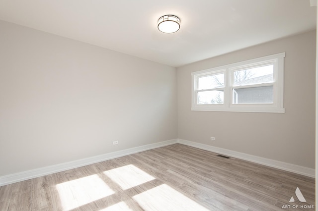 spare room with light hardwood / wood-style floors