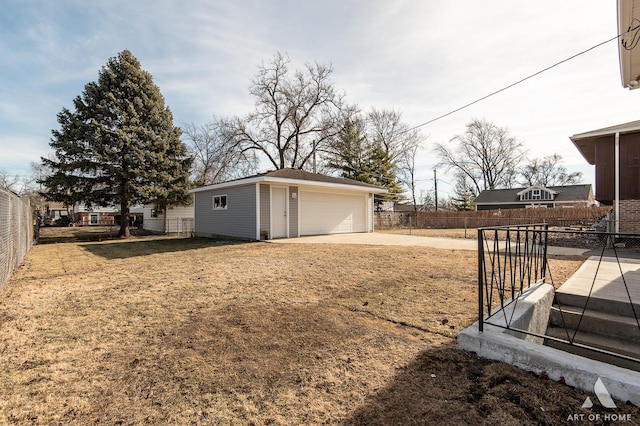 view of yard featuring a garage and an outbuilding