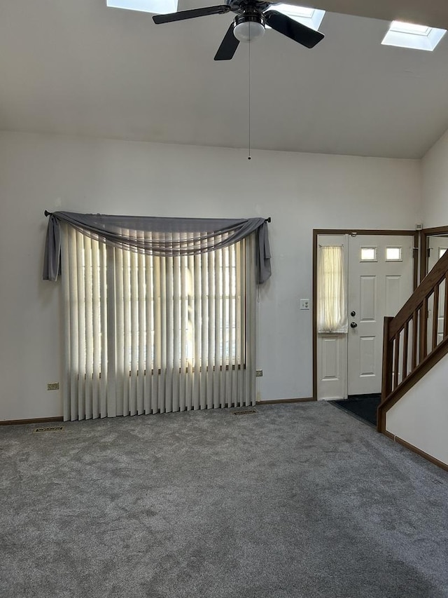 interior space featuring lofted ceiling, ceiling fan, and carpet