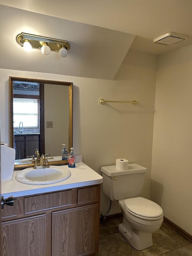 bathroom with vanity, tile patterned flooring, and toilet