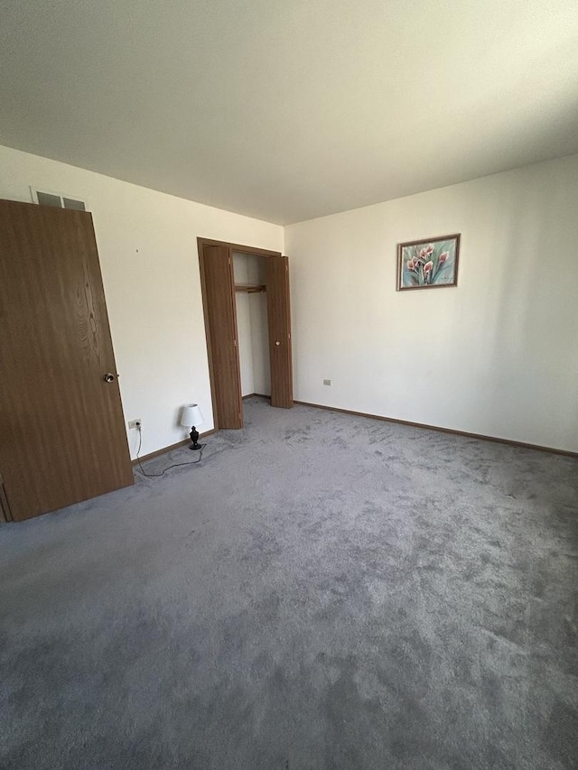 unfurnished bedroom with a closet and carpet flooring