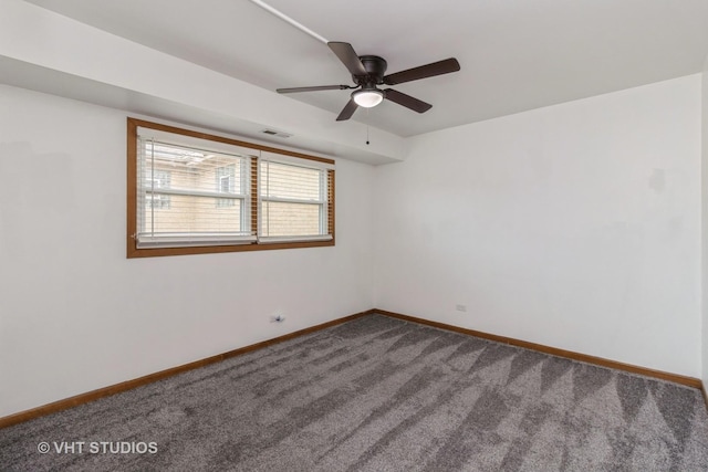 carpeted spare room with ceiling fan