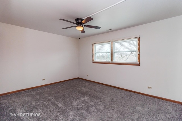 carpeted spare room with ceiling fan