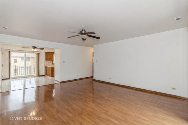 spare room featuring ceiling fan and light hardwood / wood-style floors