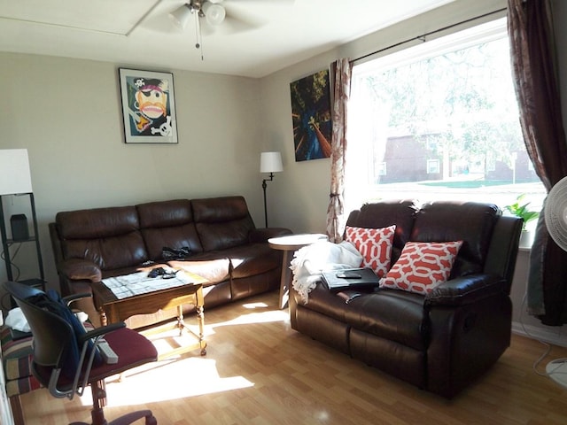 living room with light hardwood / wood-style flooring and ceiling fan