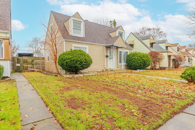 cape cod-style house with a front yard