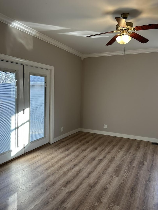 empty room with crown molding, ceiling fan, and light wood-type flooring