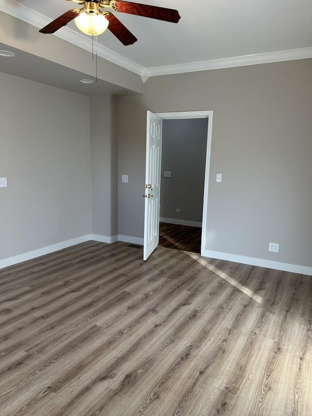 unfurnished room with crown molding, ceiling fan, and wood-type flooring