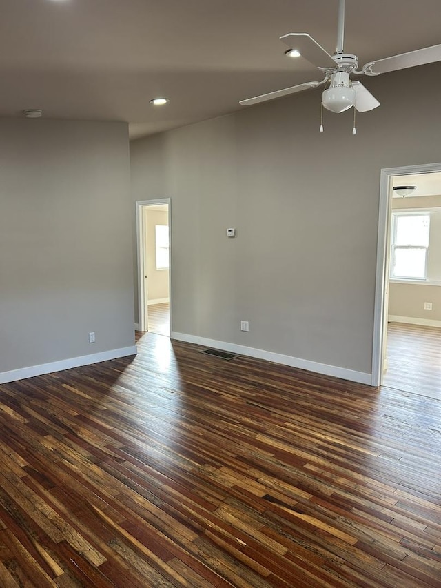 empty room featuring dark wood-type flooring and ceiling fan