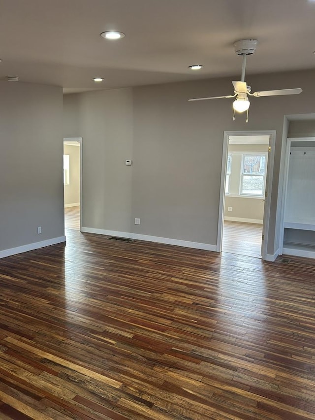 spare room with ceiling fan and dark hardwood / wood-style floors