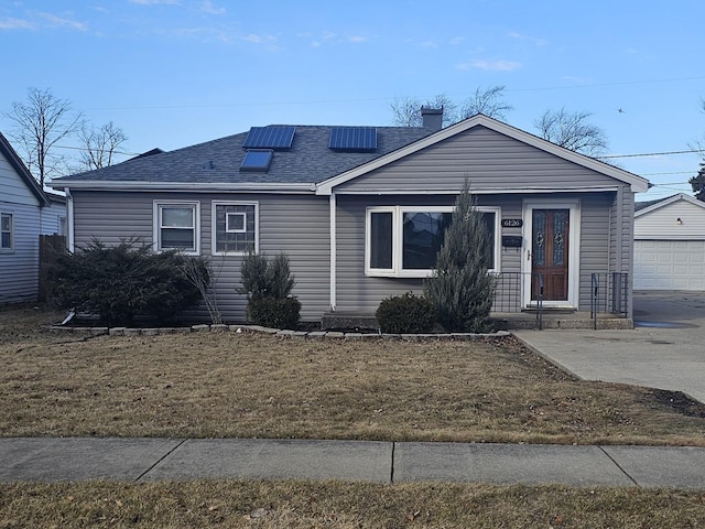 view of front of house with a garage and a front lawn