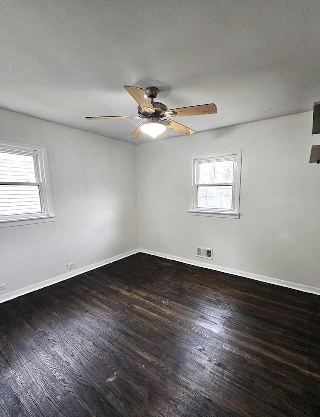 unfurnished room featuring a textured ceiling, dark hardwood / wood-style floors, and ceiling fan