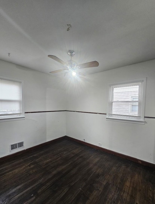 spare room featuring dark hardwood / wood-style floors and ceiling fan