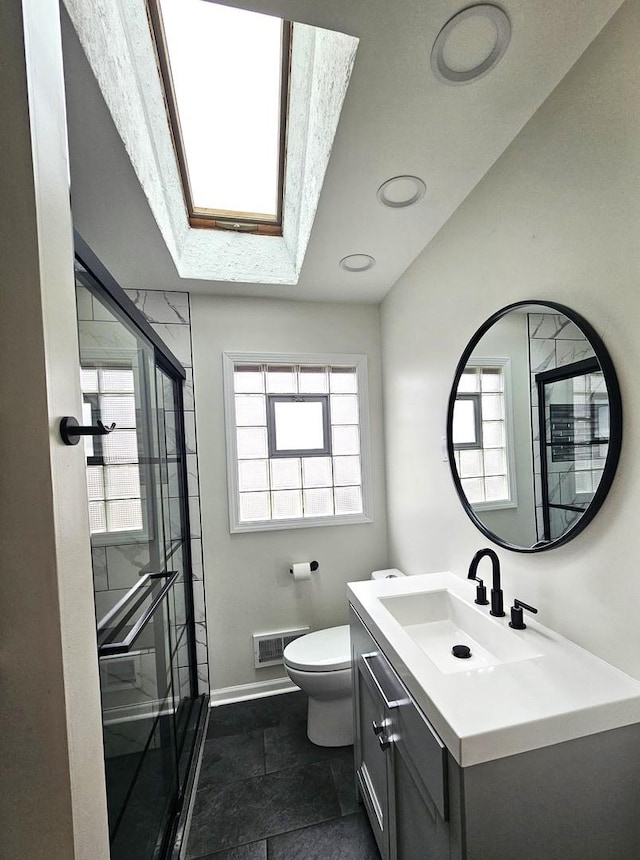 bathroom with walk in shower, plenty of natural light, toilet, and vanity