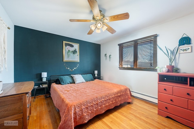 bedroom featuring a baseboard radiator, ceiling fan, and light wood-type flooring