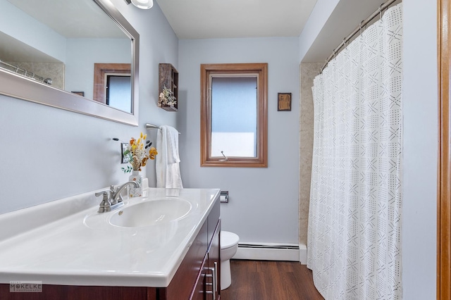 bathroom with a baseboard heating unit, vanity, wood-type flooring, toilet, and walk in shower