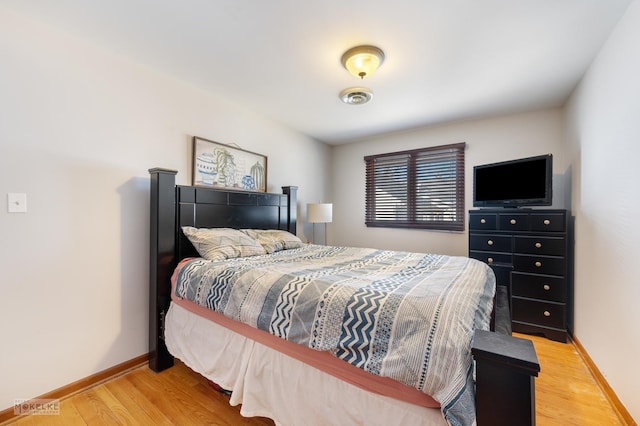 bedroom with hardwood / wood-style floors