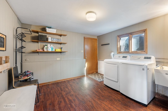 laundry room with separate washer and dryer, sink, and dark hardwood / wood-style flooring