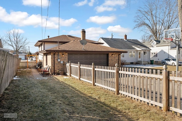 view of side of home with a garage and a lawn