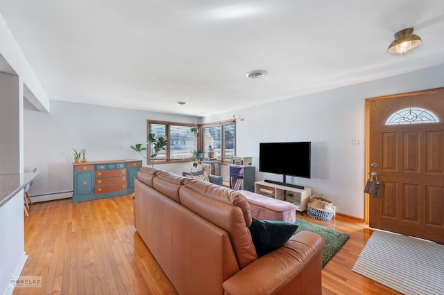 living room featuring a baseboard radiator and light hardwood / wood-style flooring