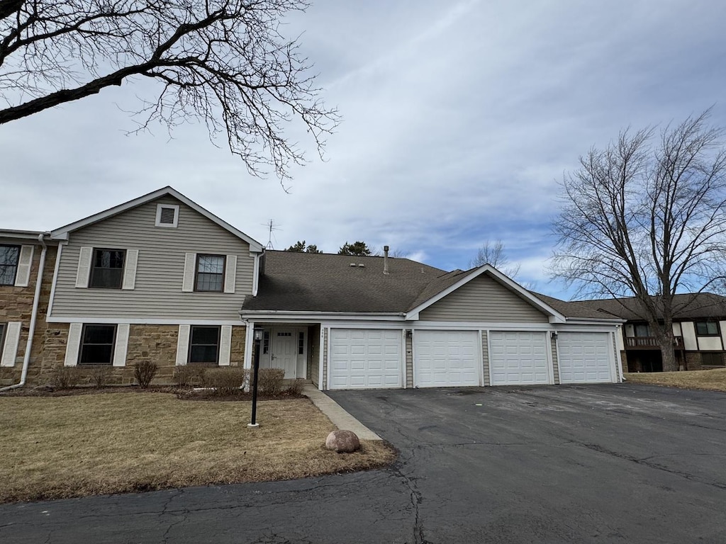 view of front of house with a garage and a front yard