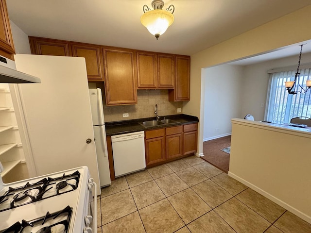 kitchen with sink, light tile patterned floors, pendant lighting, white appliances, and decorative backsplash