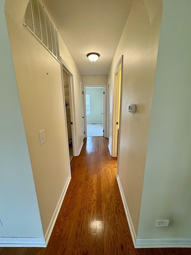 hall with hardwood / wood-style floors