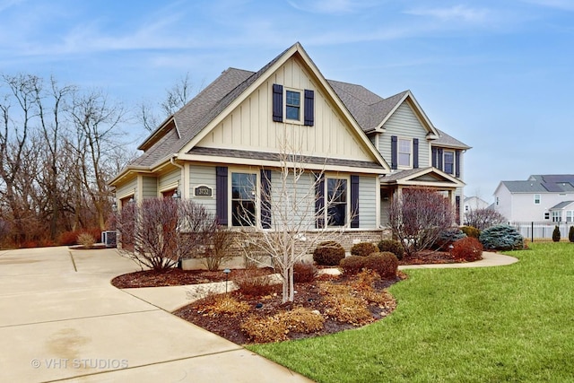 view of front of house featuring a front yard and central air condition unit