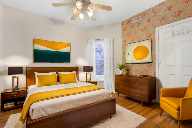 bedroom with ceiling fan and hardwood / wood-style floors