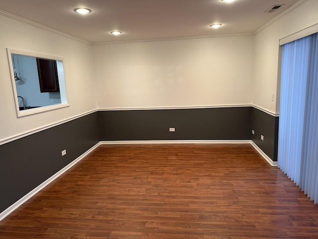 empty room with ornamental molding and dark hardwood / wood-style floors