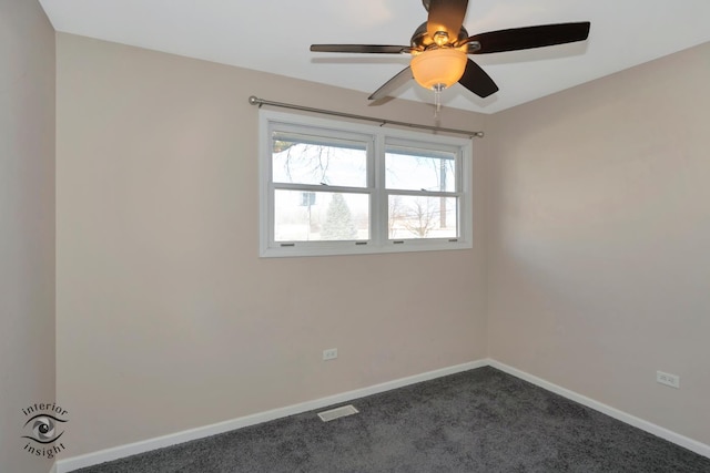 carpeted spare room featuring ceiling fan